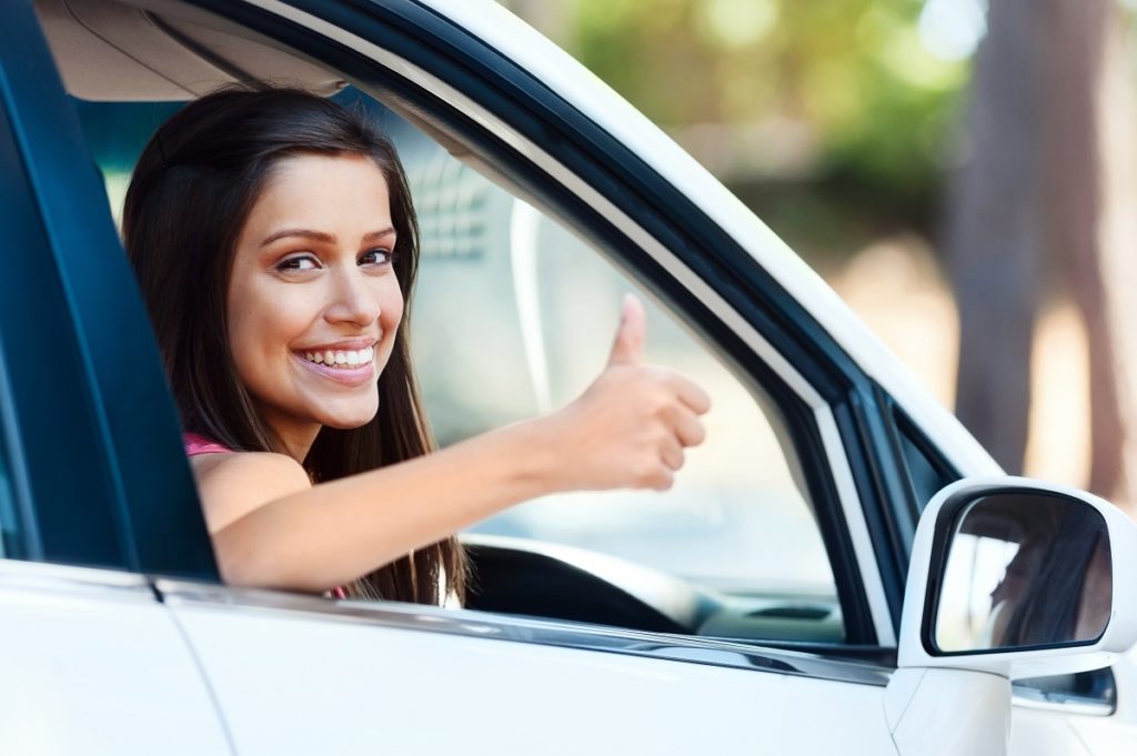 woman giving thumbs up in the car